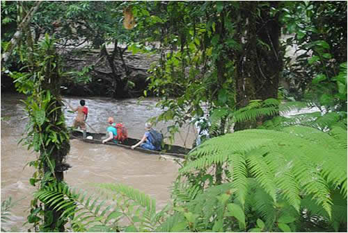 The OWC Amazon Rain Forest School Project team crosses a river in the Ecuadorian Amazon in 2011.