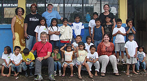 OneWorld Classrooms volunteers with students at the Puyopungo Elementary School.