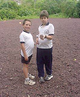 Students from Tomas de Berlanga showing lava from the road